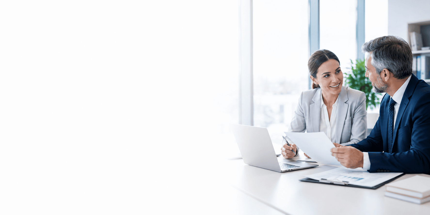 Two institutional partners reviewing publishing agreement documents together in an office.